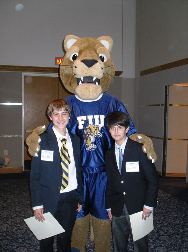 40 Award winners Enrique Mercado and Daniel Romero pose with the FIU mascot, the Golden Panther